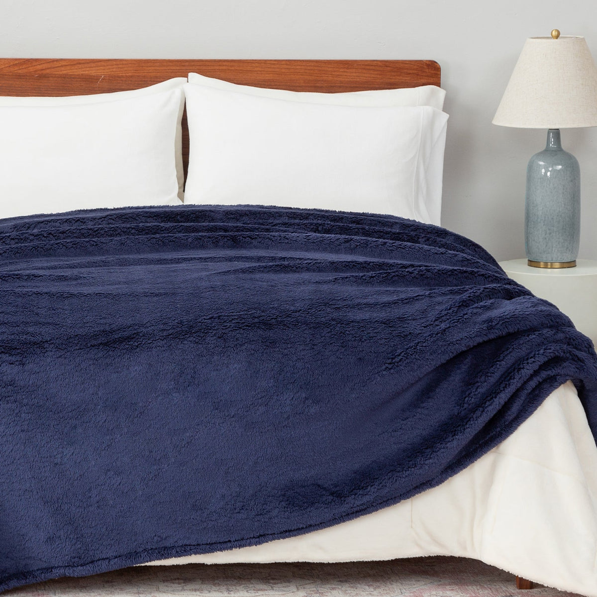 Image of a bed styled with a white waffle blanket