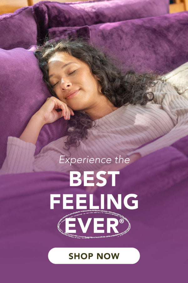 Woman lying on a purple bed with text 'Experience the Best Feeling Ever' and 'Shop Now' button.