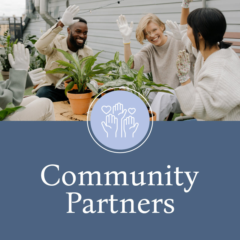 Group of multicultural people sitting together giving each other high-fives. Caption reads "Community Partners" with an icon of hands and hearts.