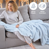 Infographic of our Premium Extra-Fluffy fabric with more plush and more comfort with a woman sitting on a grey sofa with a blue throw.