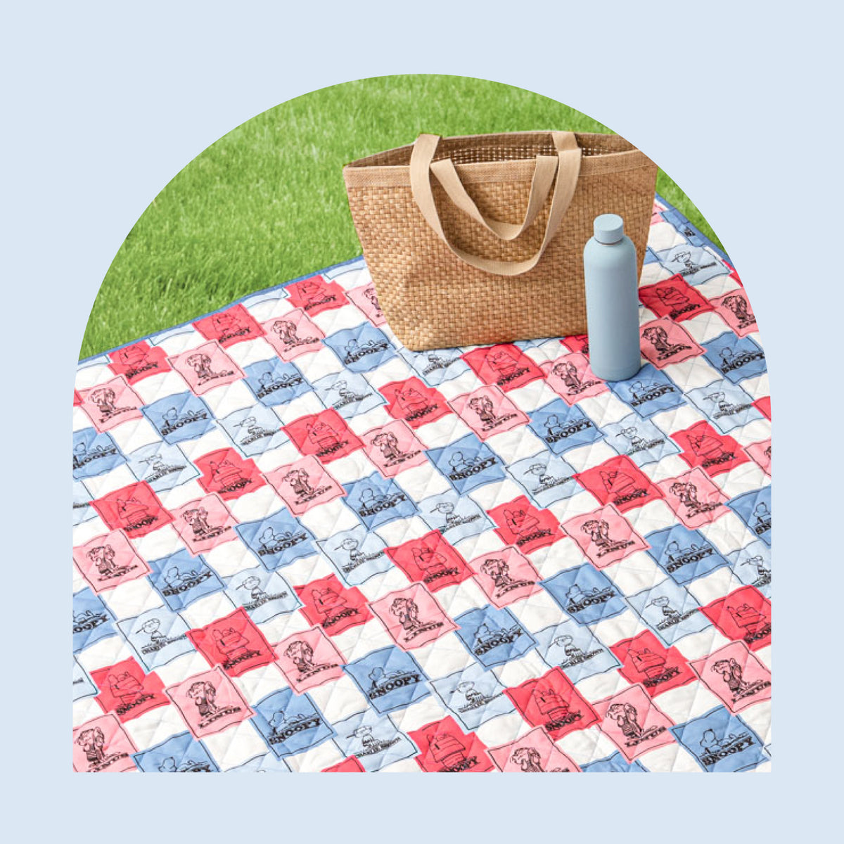Image of an outdoor throw featuring a tiled artwork design of pinks and blues.