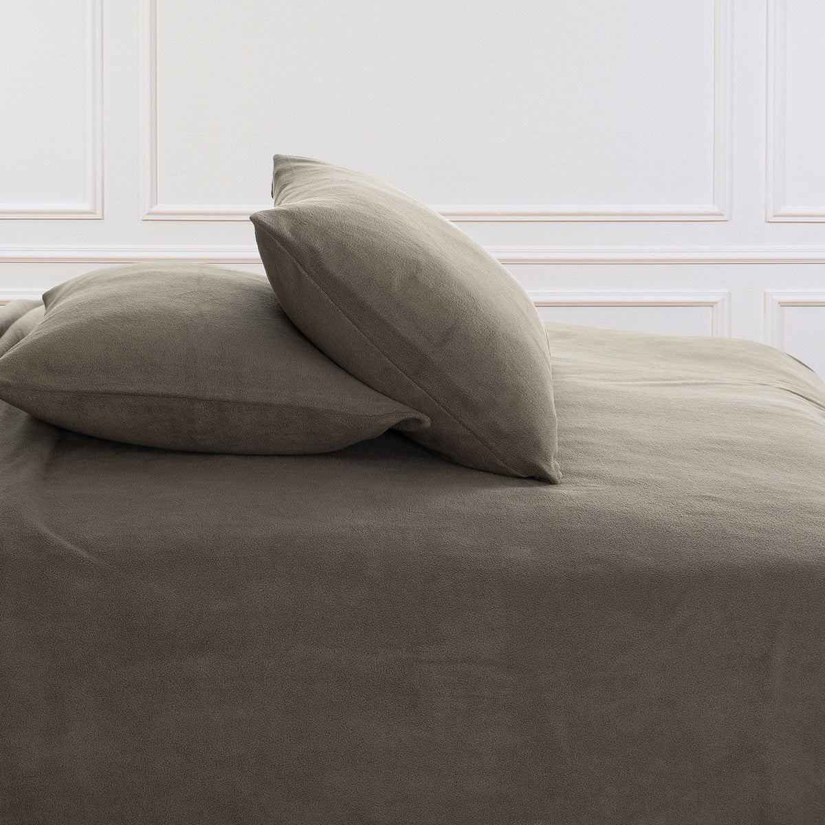 All-Season Microfleece Sheet Set pillowcases in Kalamata on a made bed against a white paneled wall