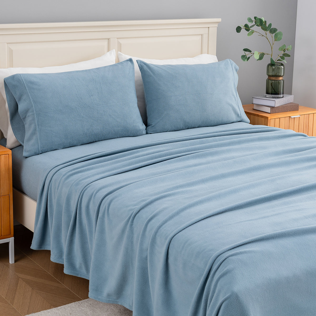 All-Season Microfleece Sheet Set in Slate Blue on a made bed, angled view