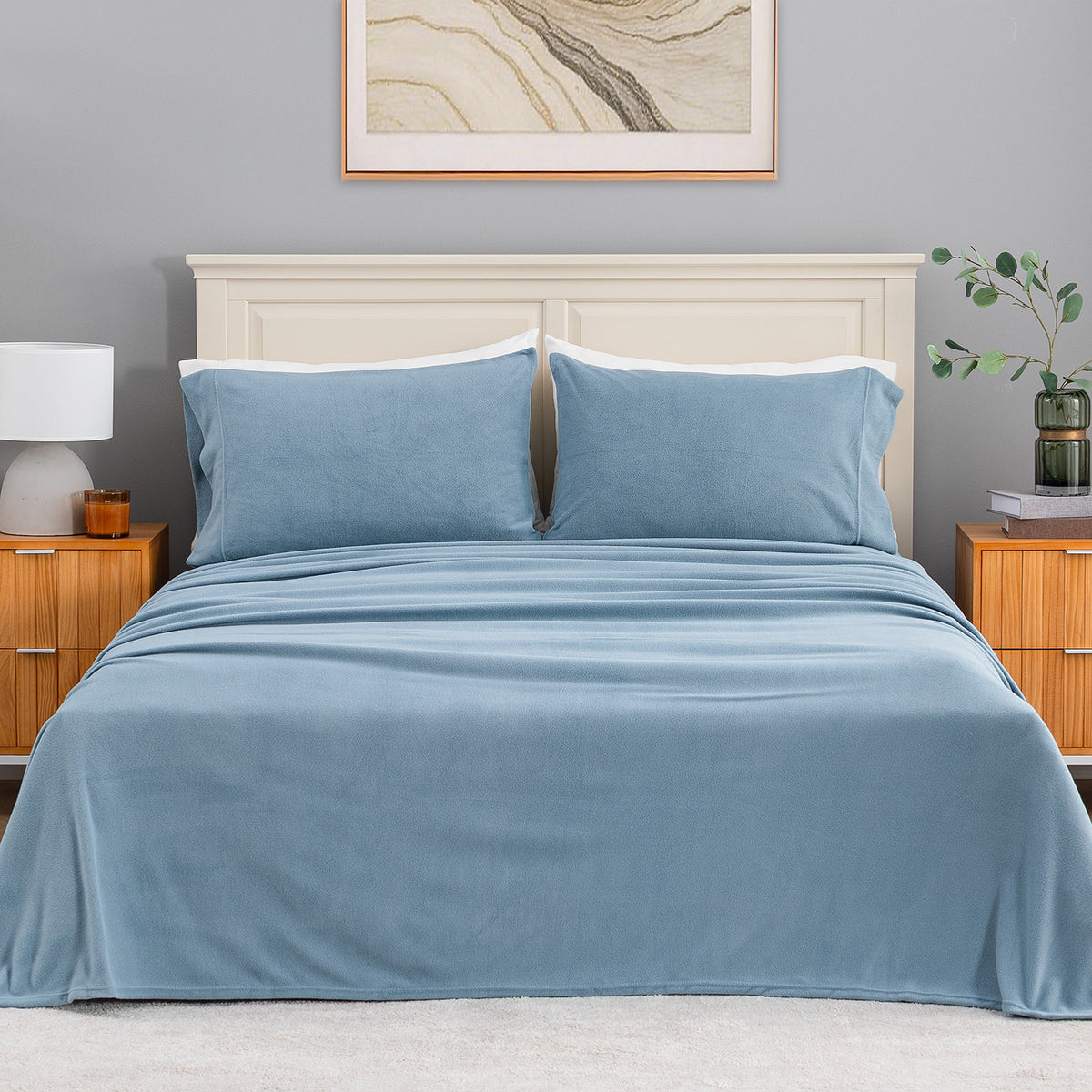 All-Season Microfleece Sheet Set in Slate Blue on a made bed with a cream headboard, front view