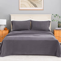 All-Season Microfleece Sheet Set in Space Grey on a made bed with a cream headboard, front view