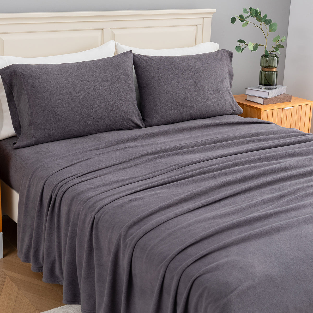 All-Season Microfleece Sheet Set in Space Grey on a made bed, angled view