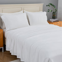All-Season Microfleece Sheet Set in True White on a made bed, angled view