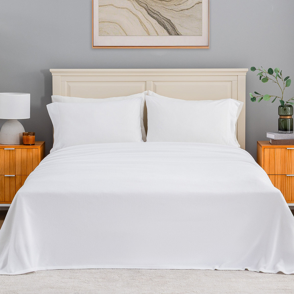 All-Season Microfleece Sheet Set in True White on a made bed with a cream headboard, front view