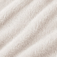A close-up of a soft, plush faux fur fabric in a warm off-white or cream color, showing the textured pile and draped folds.