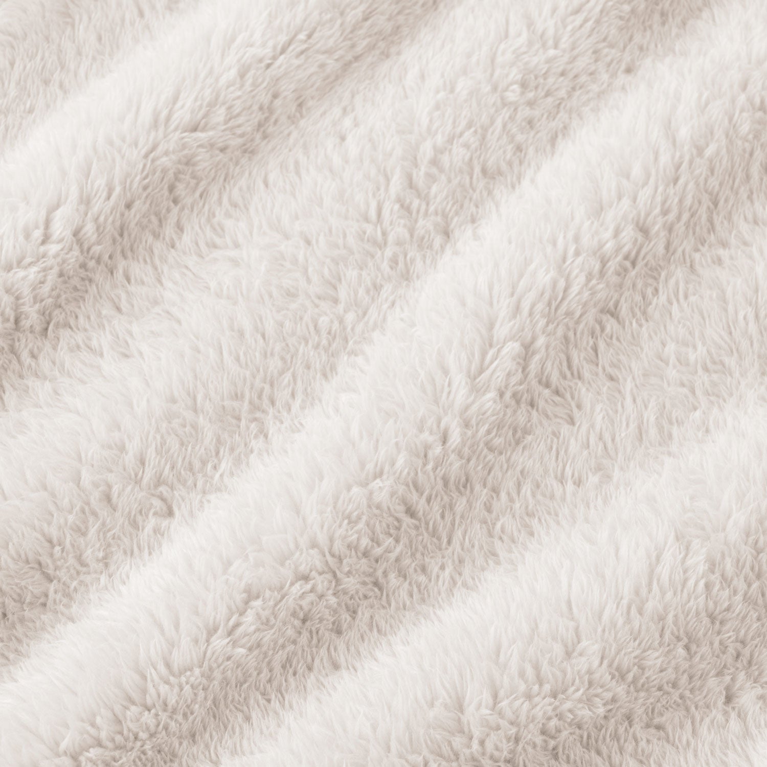 A close-up of a soft, plush faux fur fabric in a warm off-white or cream color, showing the textured pile and draped folds.