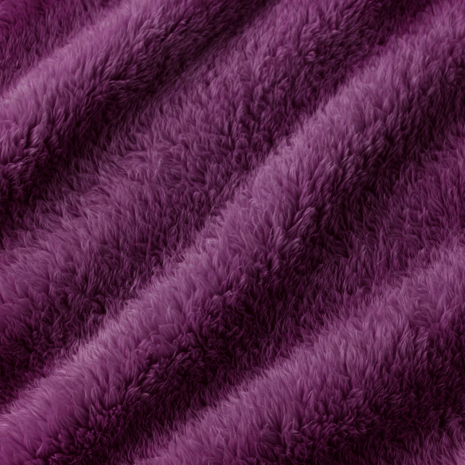 A close-up of plush, shaggy faux fur fabric in a rich purple color, showing the soft texture and folds.