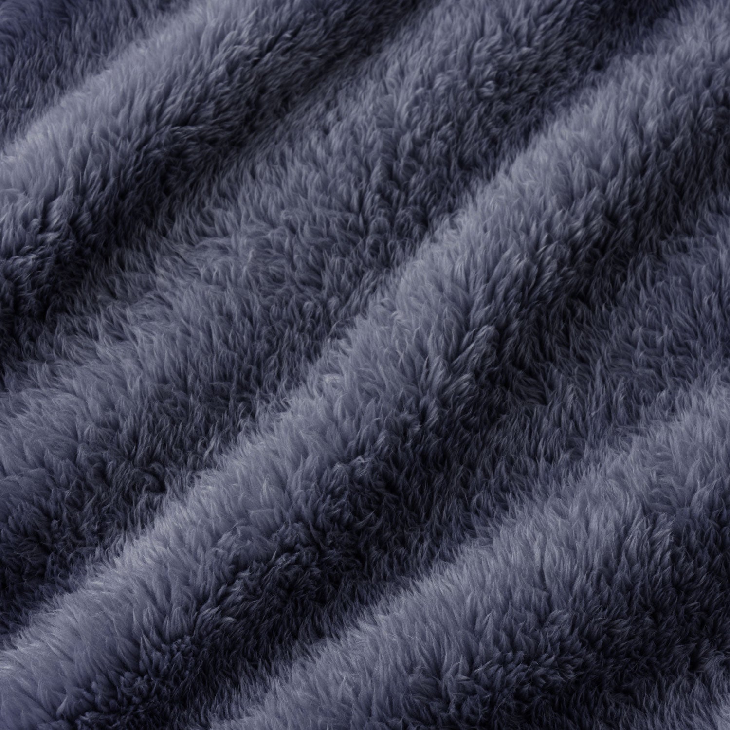 A close-up of plush faux fur fabric in a dark slate gray color, showing the soft texture and diagonal folds.