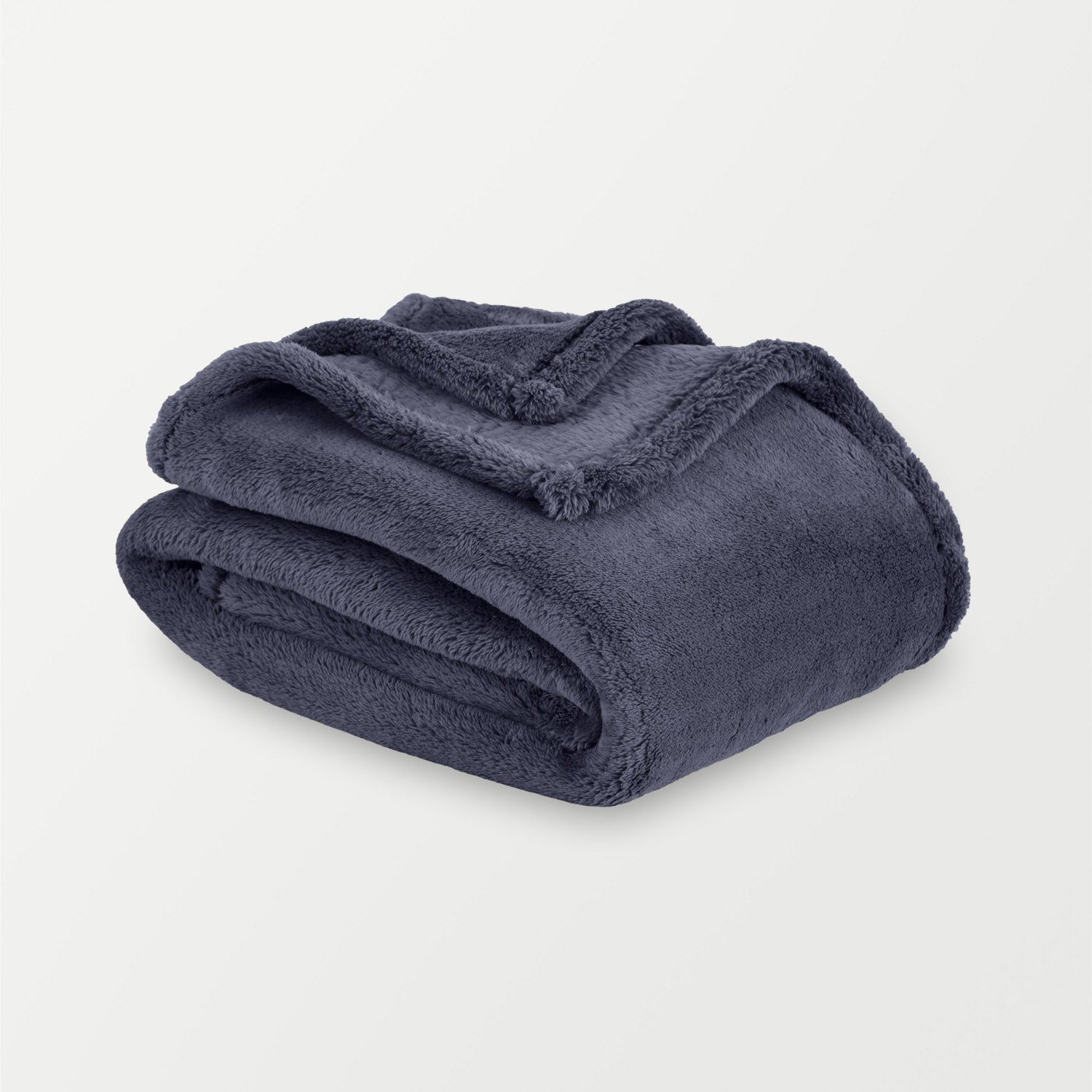 Folded navy blue blanket on a light gray background