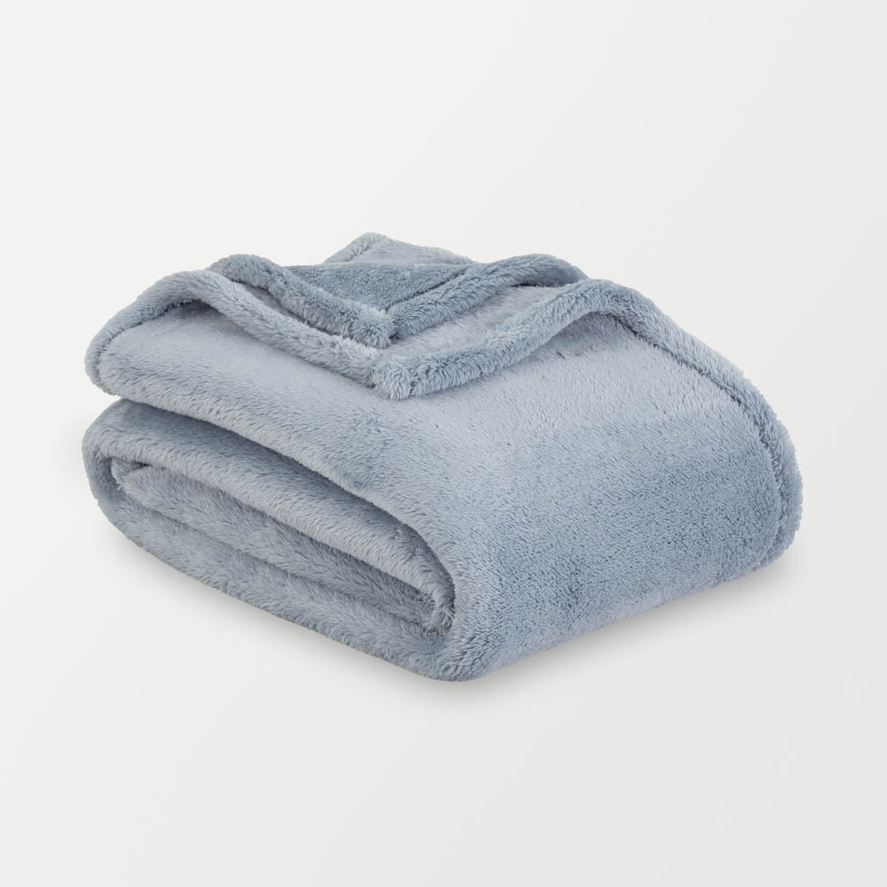Folded blue blanket on a white background