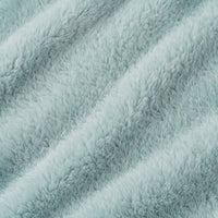 A close-up of a soft, plush faux fur fabric in a pale icy blue color, showing the textured pile and diagonal folds.