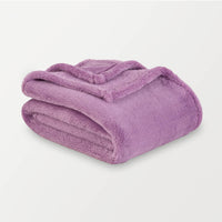 Folded purple blanket on a light gray background