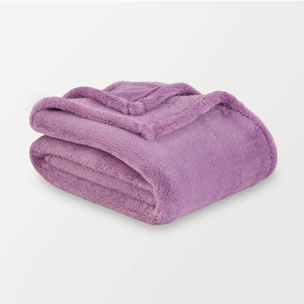 Folded purple blanket on a light gray background