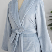 A light blue VelvetLoft Robe on a mannequin with a belt neatly tied around the waist.