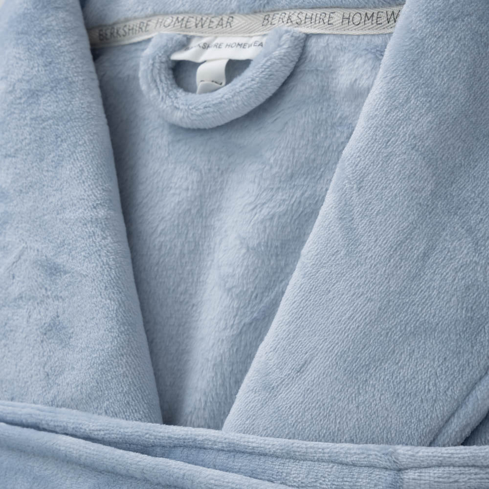 A close-up showing the plush texture of a light blue VelvetLoft Robe.