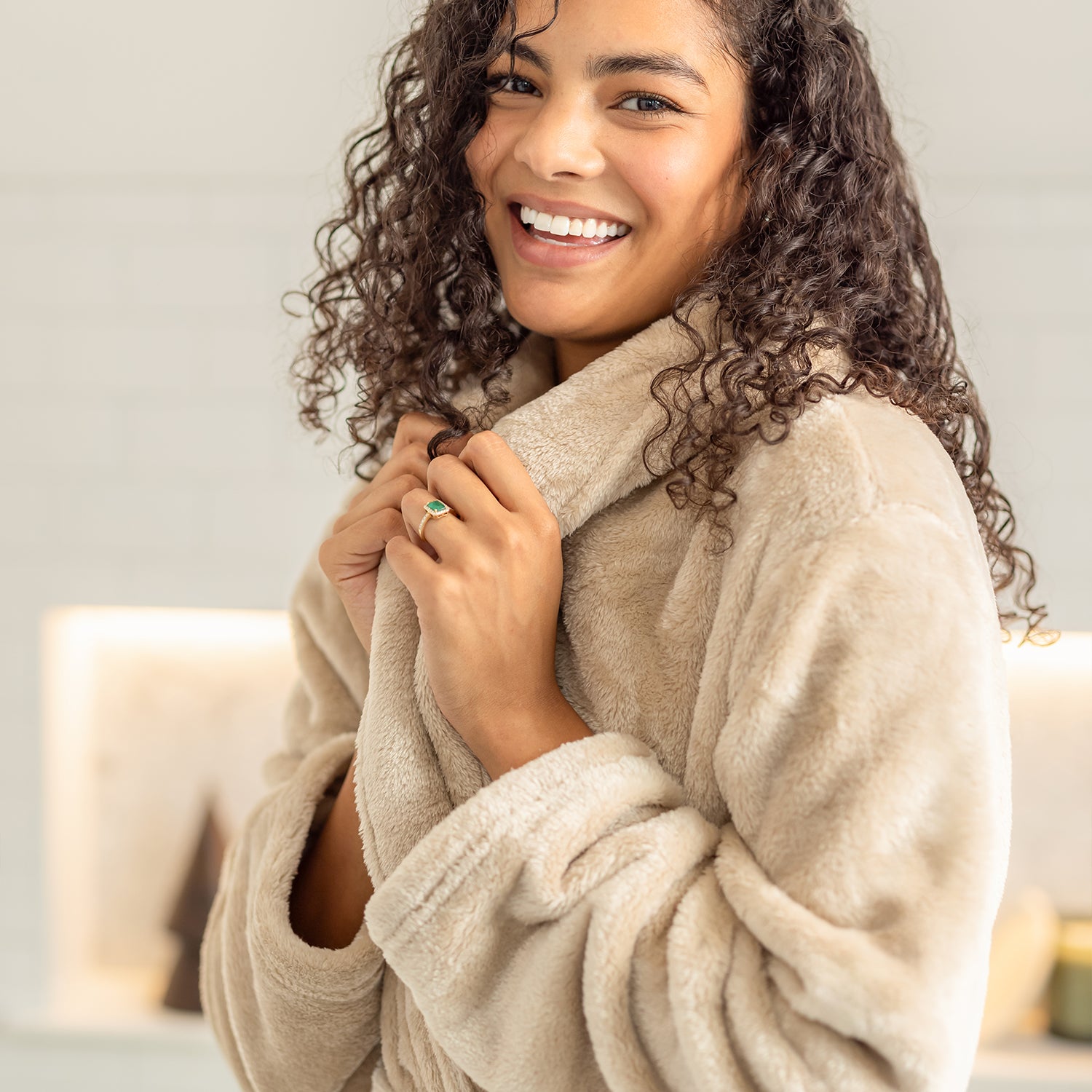Woman wearing a beige robe with a neutral background