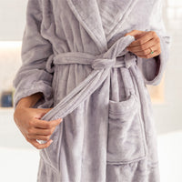 Person wearing a lilac plush robe with a belt, against a neutral background