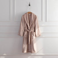 A pink VelvetLoft Robe displayed on a hanger, styled with a belt tied neatly at the waist.