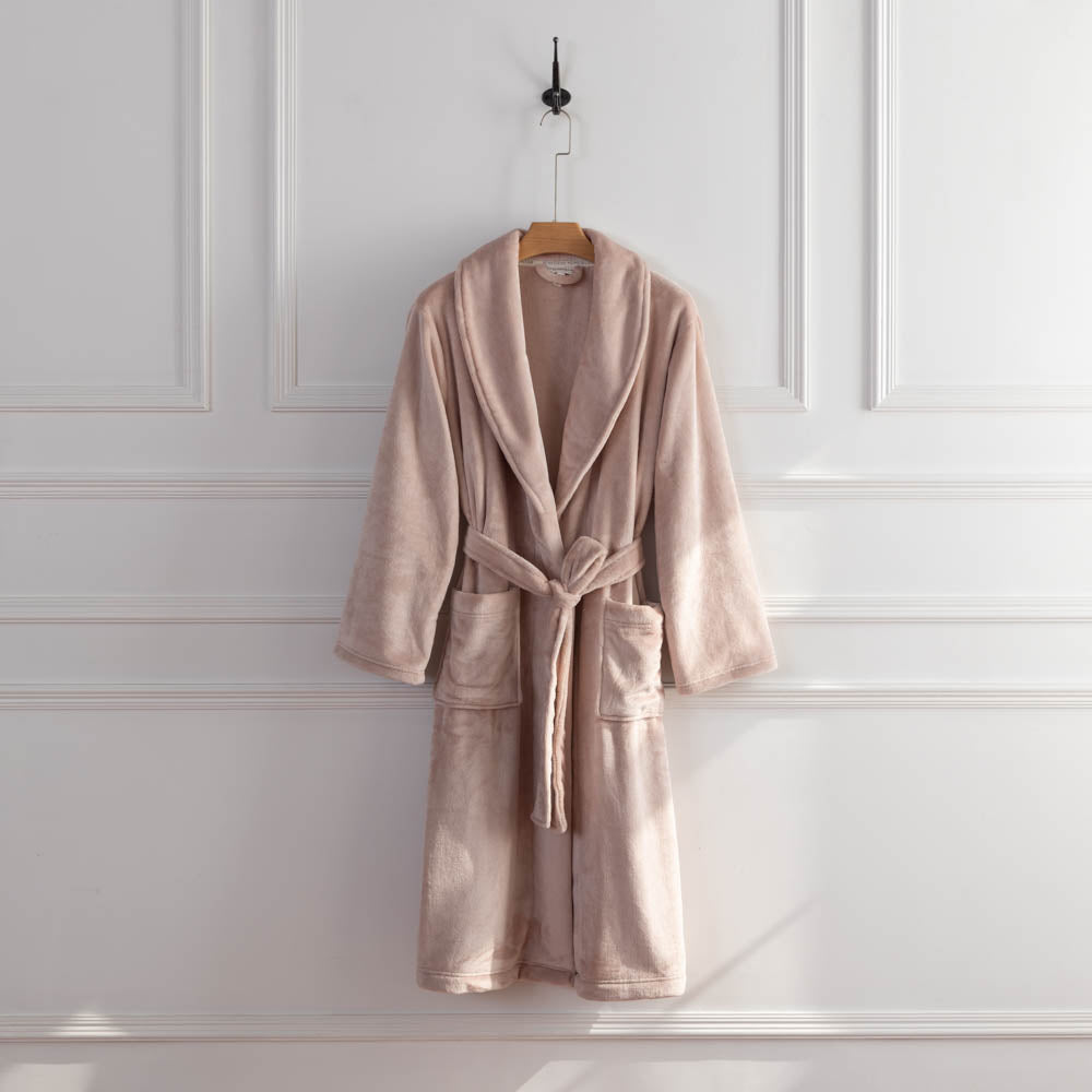 A pink VelvetLoft Robe displayed on a hanger, styled with a belt tied neatly at the waist.