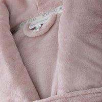 A close-up of the velvety texture of a blush pink VelvetLoft Robe.