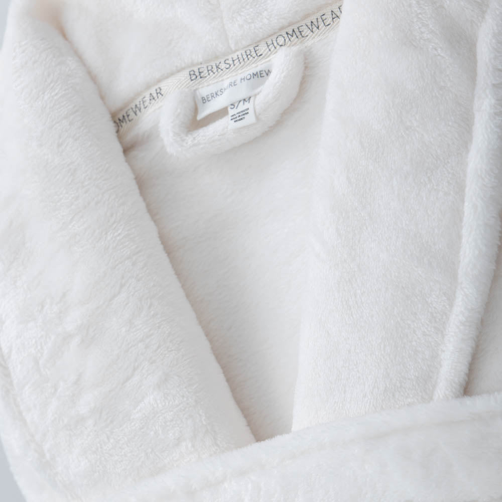 A close-up of the soft, velvety texture of a white VelvetLoft Robe.