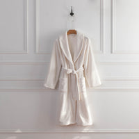 A white VelvetLoft Robe draped neatly over a hanger against a white wall.