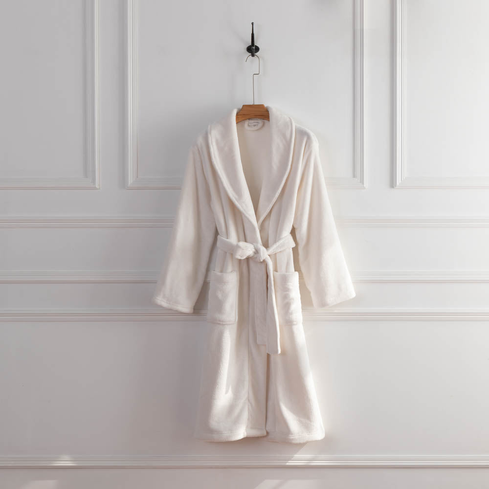 A white VelvetLoft Robe draped neatly over a hanger against a white wall.