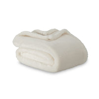 Folded white blanket on a white background