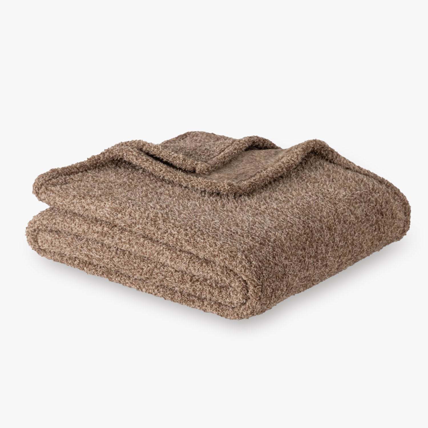 Brown throw folded neatly on a white surface.