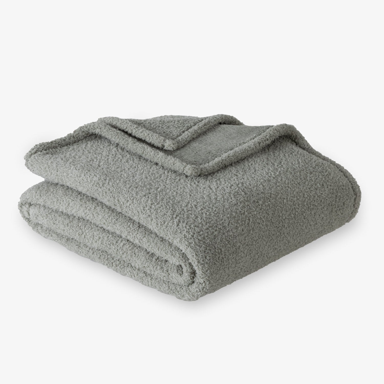 Folded green blanket on a white background
