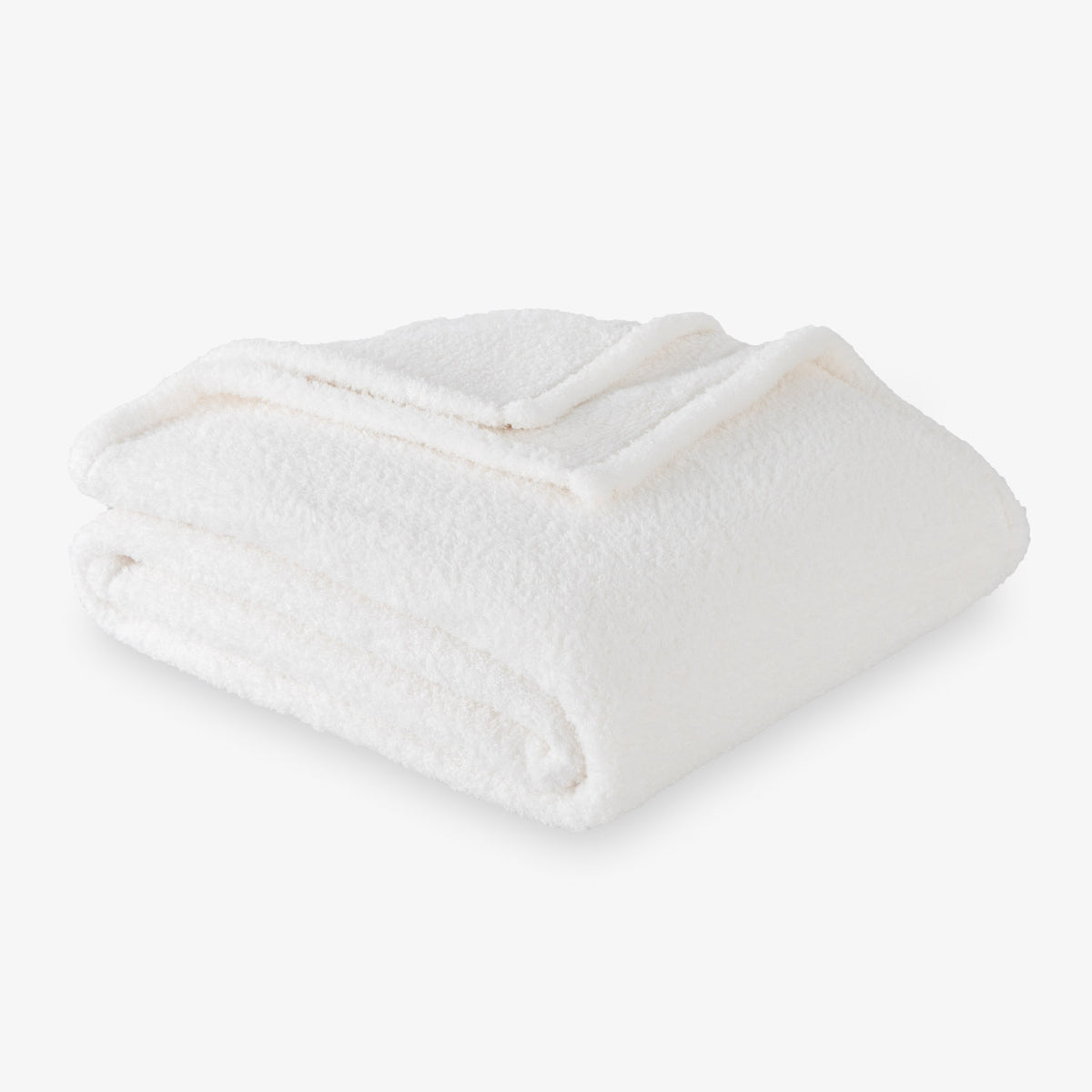 Folded white blanket on a light gray background