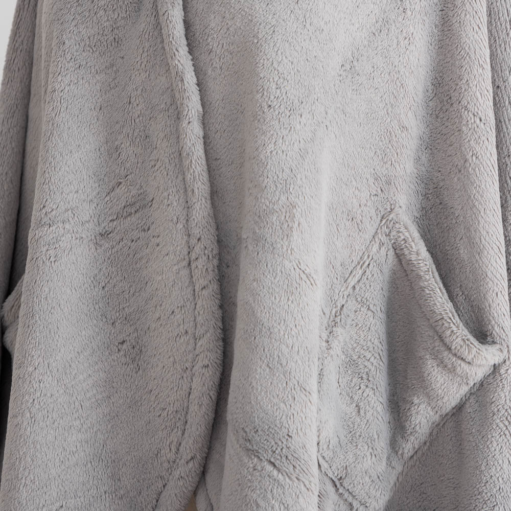 A close-up of the soft, plush texture of a gray PrimaLush Cape Wrap.
