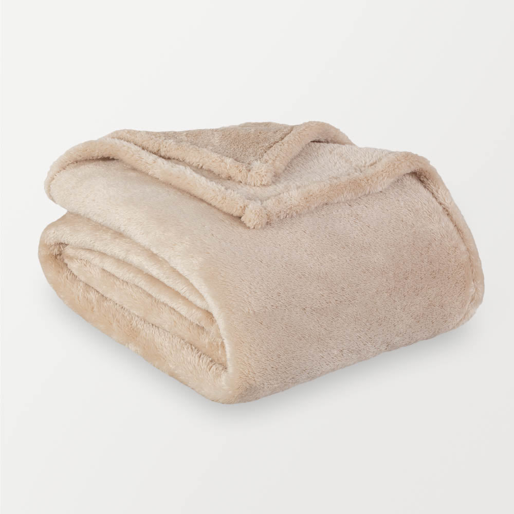 Folded beige blanket on a light gray background