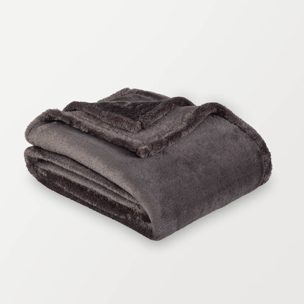 A gray fluffy blanket folded neatly on a white surface.