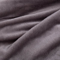 Close up of a grey velvety plush family blanket displaying its silky smooth texture.