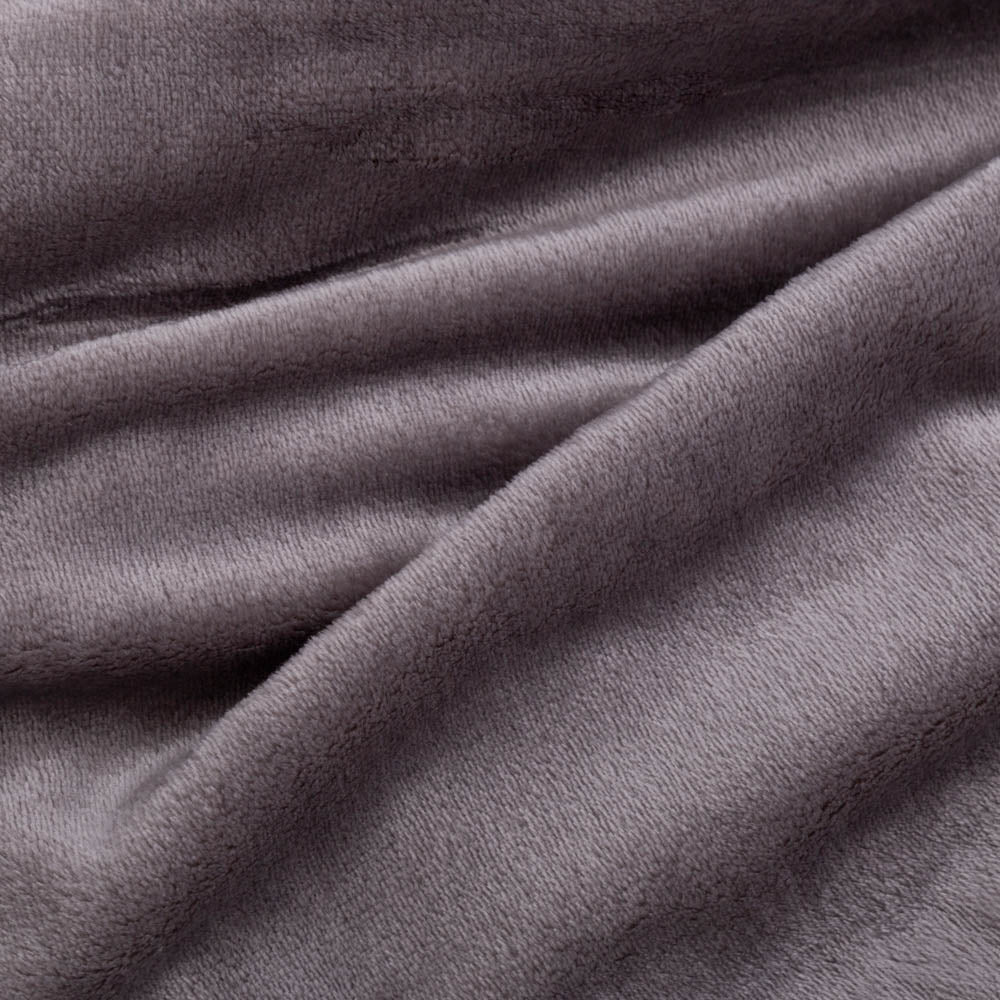Close up of a grey velvety plush family blanket displaying its silky smooth texture.
