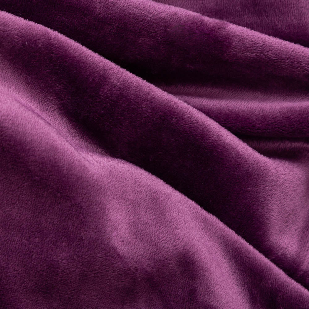 Close up of a purple velvety plush family blanket displaying its silky smooth texture.