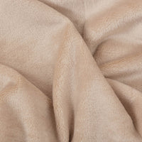 Close up of a beige velvety plush family blanket displaying its silky smooth texture.
