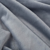 Close up of a blue velvety plush family blanket displaying its silky smooth texture.