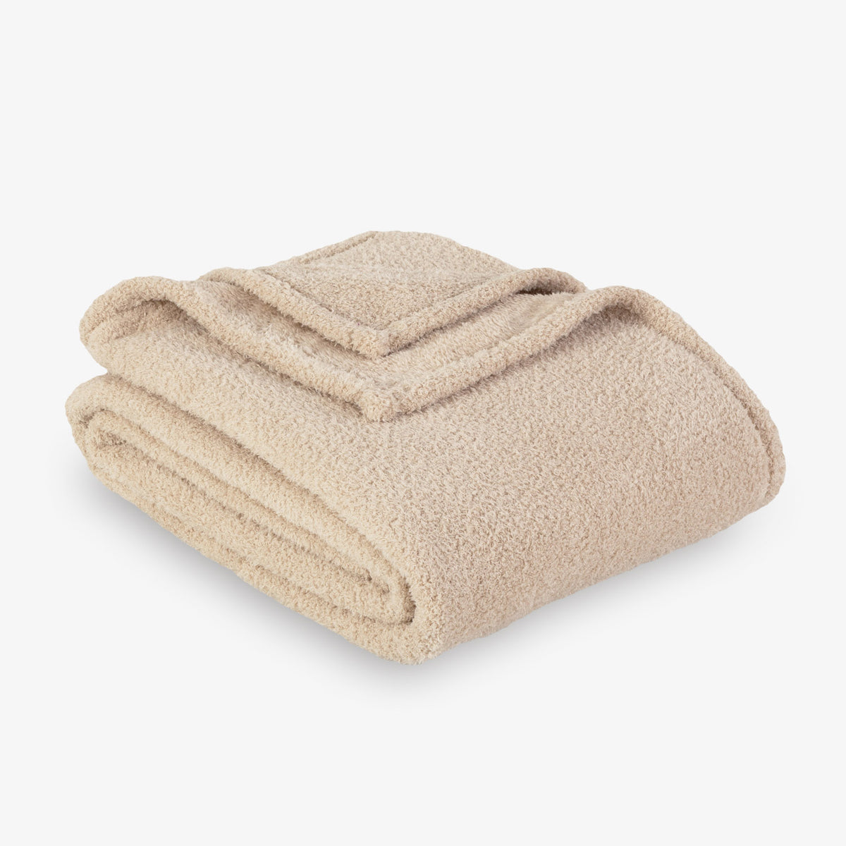 Folded beige blanket on a white background
