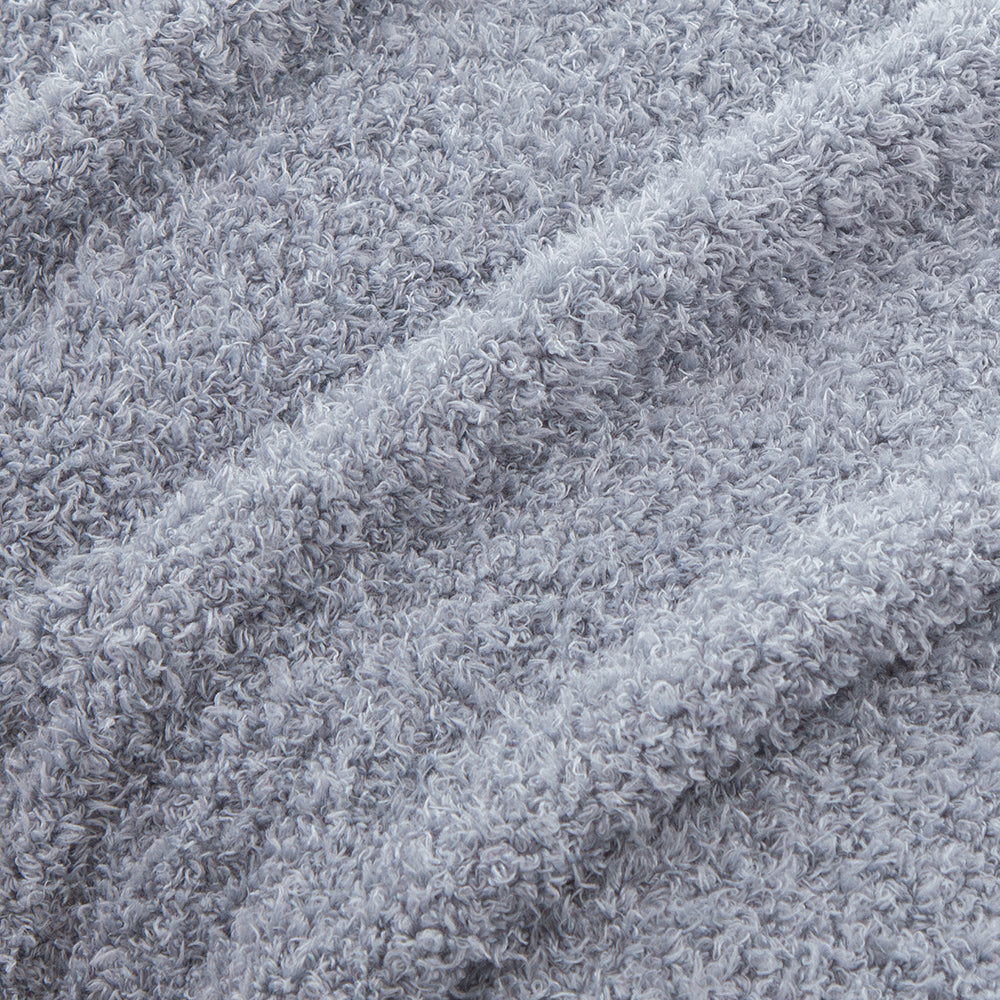 Close up of our Polar Blue Retro Comfort Plush Blanket, displaying the short curled fibers.