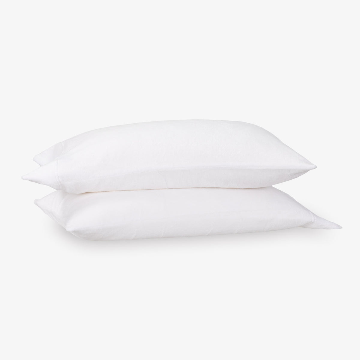 Two white pillows stacked on a light gray background