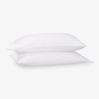 Two white pillows stacked on a light gray background