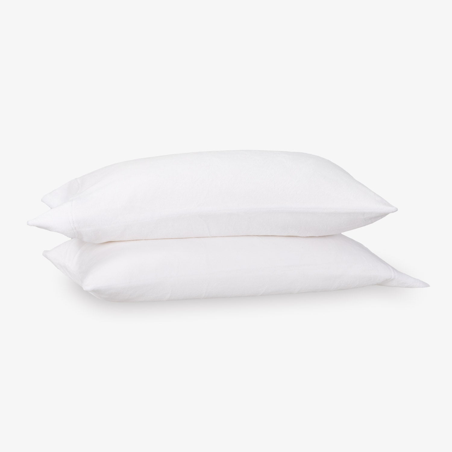 Two white pillows stacked on a light gray background