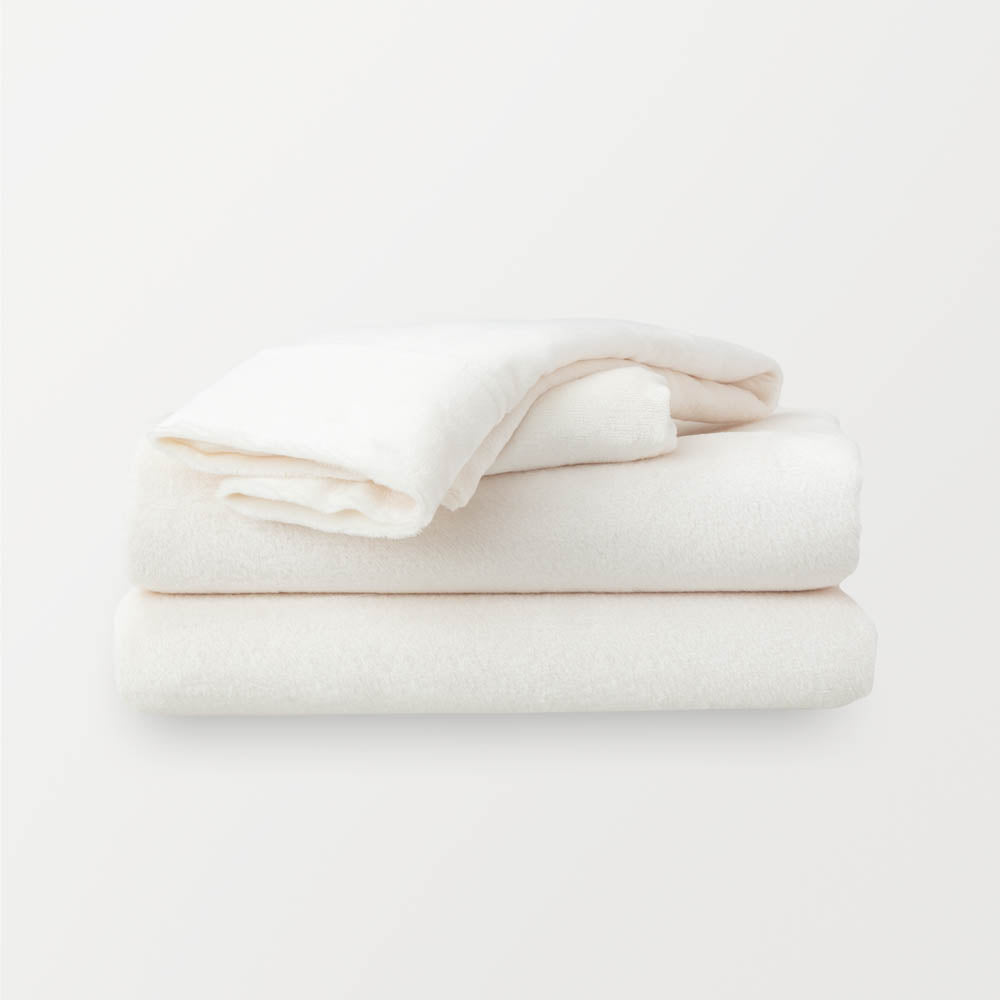 Folded Cream sheet set on a white background.