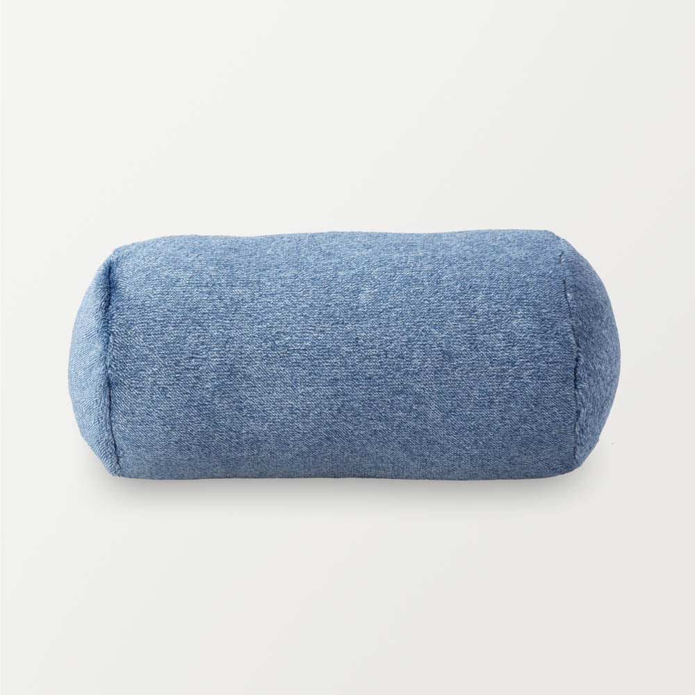 A blue EcoThread Neckroll Pillow sitting on a white surface.
